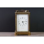 An antique brass cased carriage clock, maker marked to the face Howell James & Co.