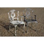A pair of painted cast metal garden chairs.