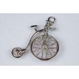 A 925 sterling silver charm in the form of a penny farthing bicycle.