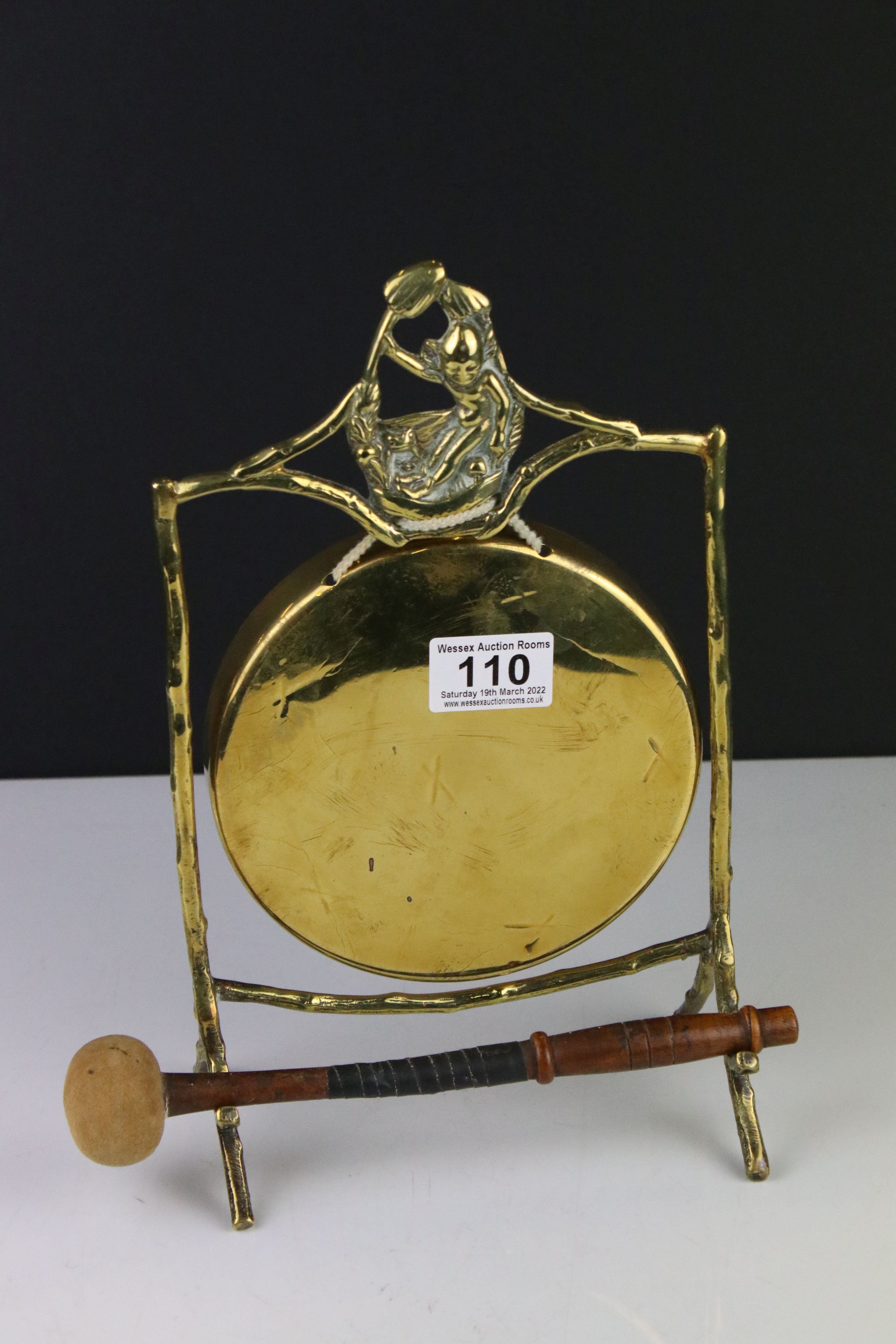 Early 20th century Brass Gong held on a stand of naturalistic form with a wooden handle striker,