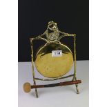 Early 20th century Brass Gong held on a stand of naturalistic form with a wooden handle striker,
