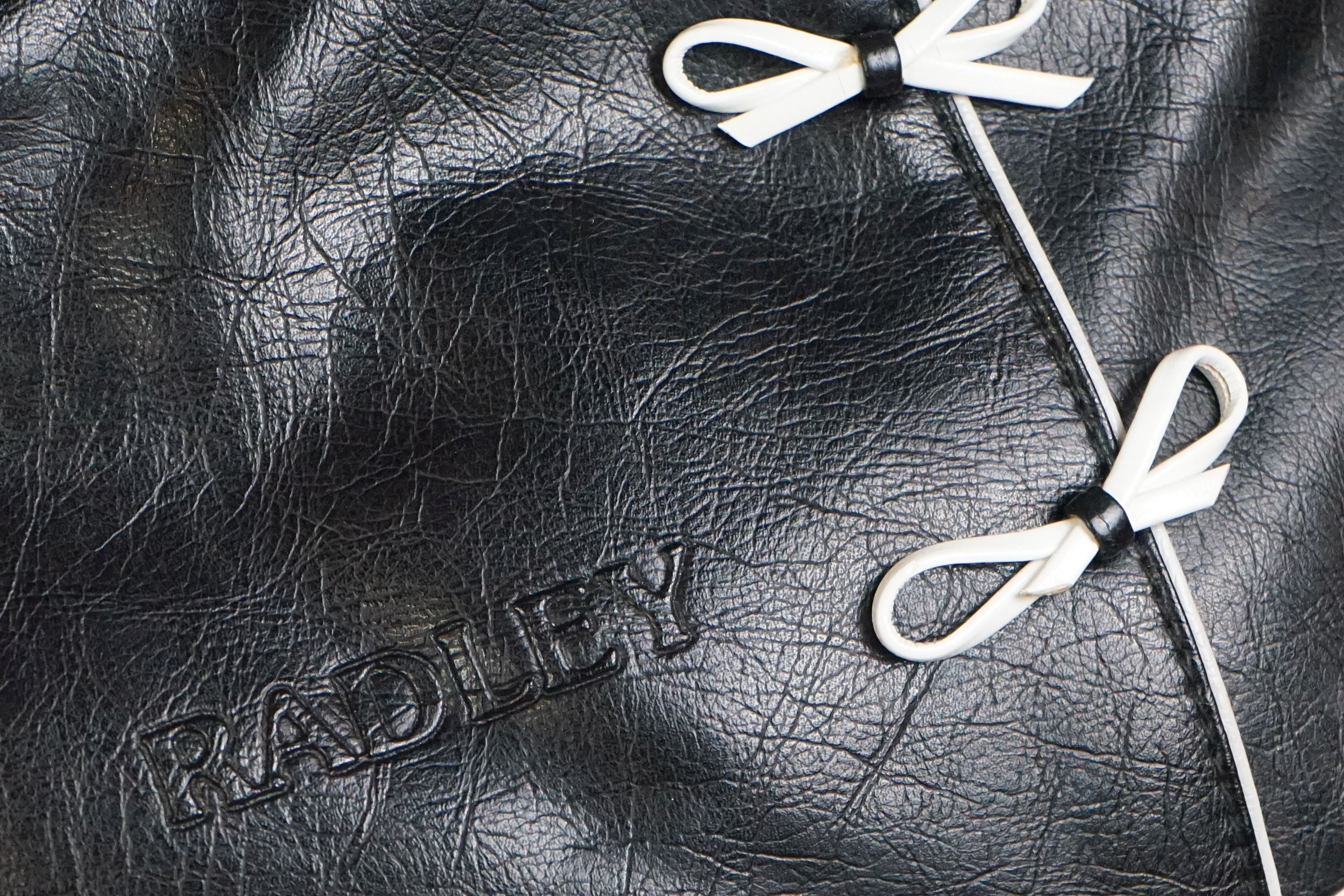 A black Radley handbag with white bow detailing, white Radley dog and pink dust bag. - Image 3 of 7