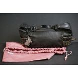 A black Radley handbag with fringed detail, grey Radley dog and pink dust bag.