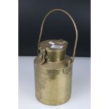 An early 20th century brass lidded canister with swing handle, possibly Trench Art