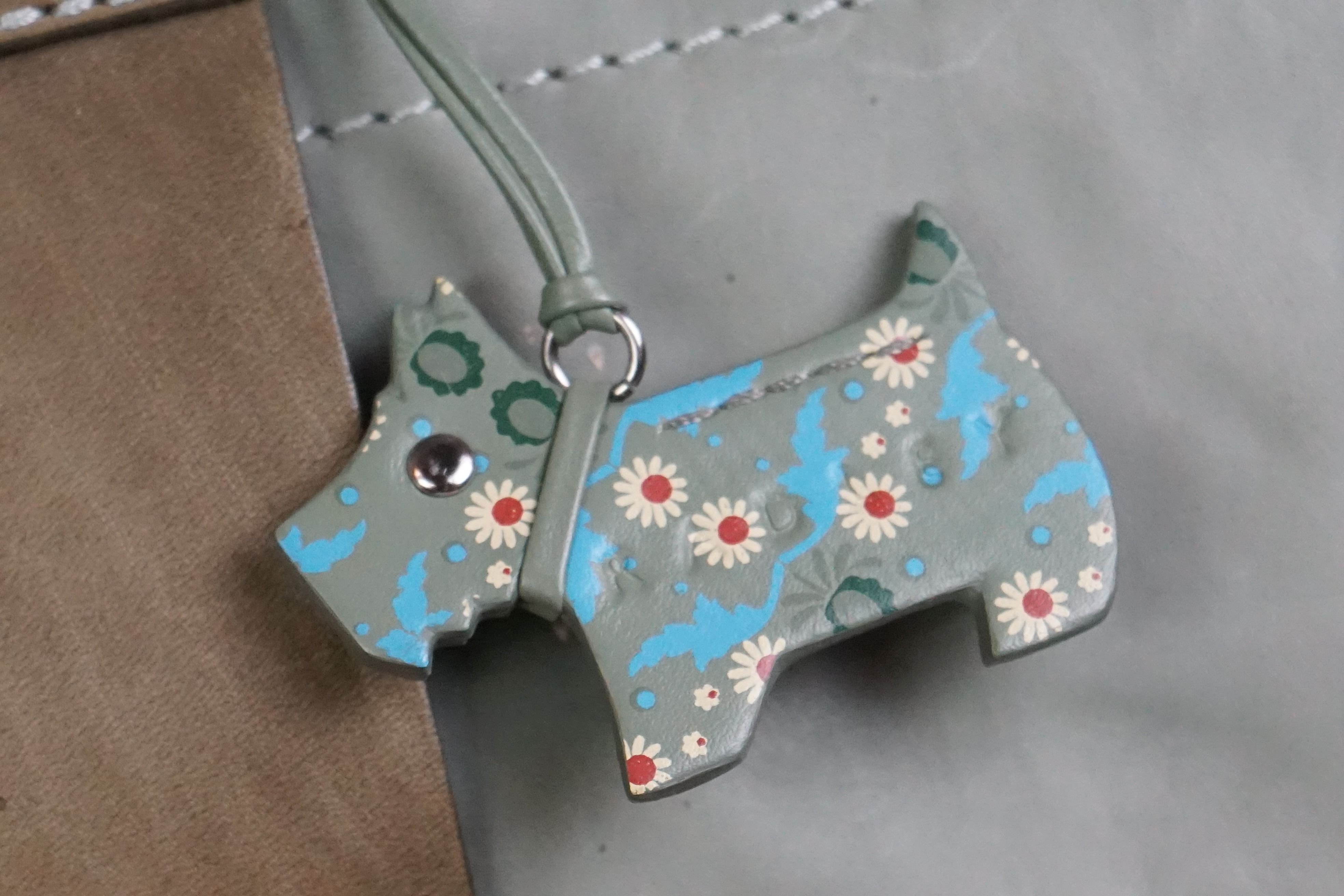 A green Radley handbag with floral metal, floral Radley dog and pink dust bag. - Image 2 of 7