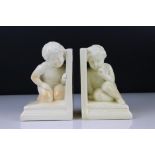 Pair of 1930's Art Deco Cream Glazed Pottery Bookends featuring small children, 14cm high