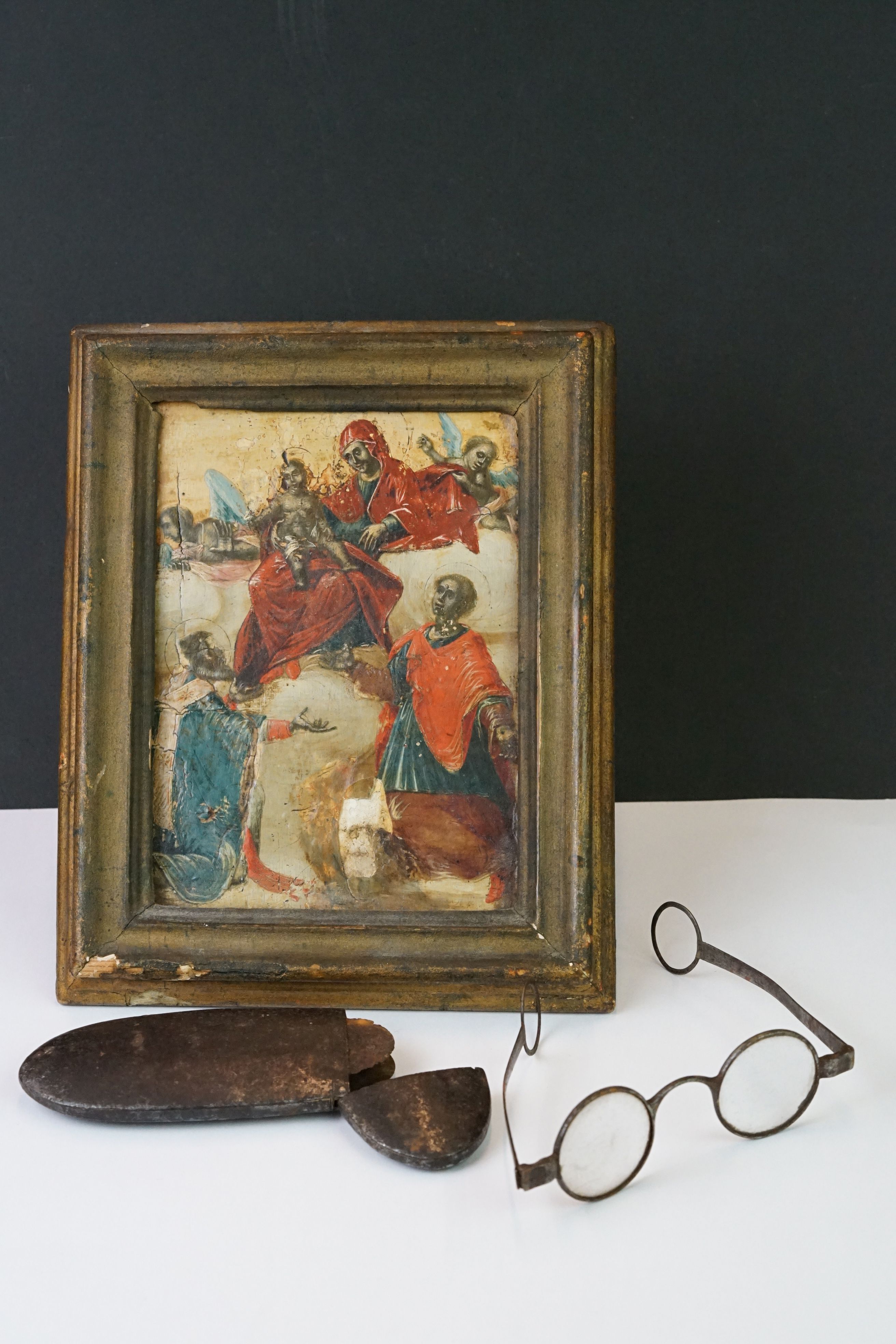 An antique Eastern European icon together with a pair on antique glasses.