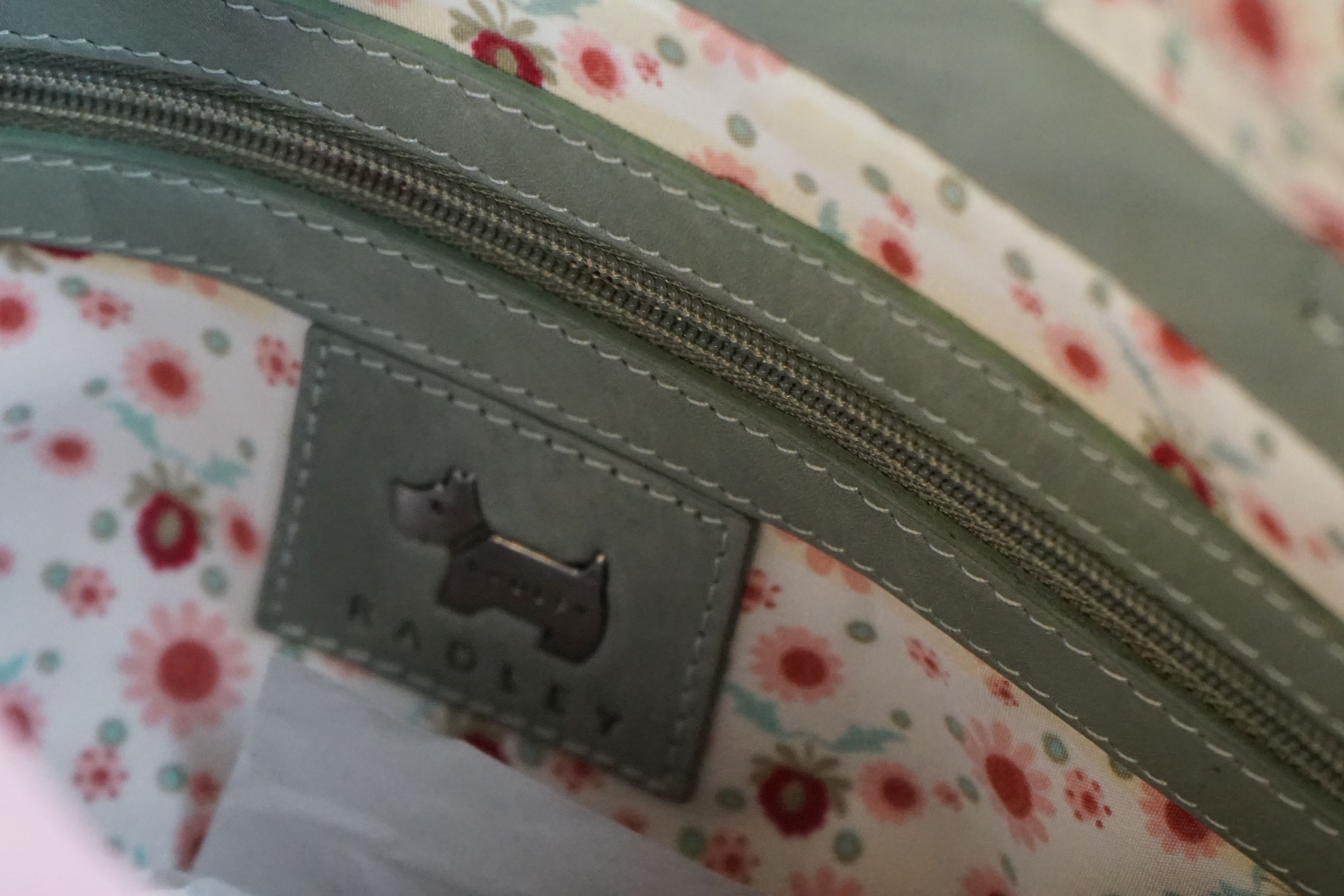 A green Radley handbag with floral metal, floral Radley dog and pink dust bag. - Image 6 of 7