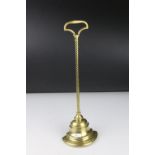 A brass door porter with weighted iron base by William Tonks & sons.