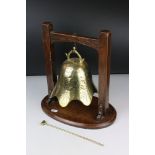Brass engraved Temple Bell with striker held on a Hardwood Stand, 34cm high