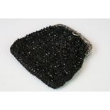 An antique black beaded purse with fully hallmarked sterling silver clasp with an assay mark for