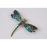 A sterling silver plique a jour brooch in the form of a dragonfly.