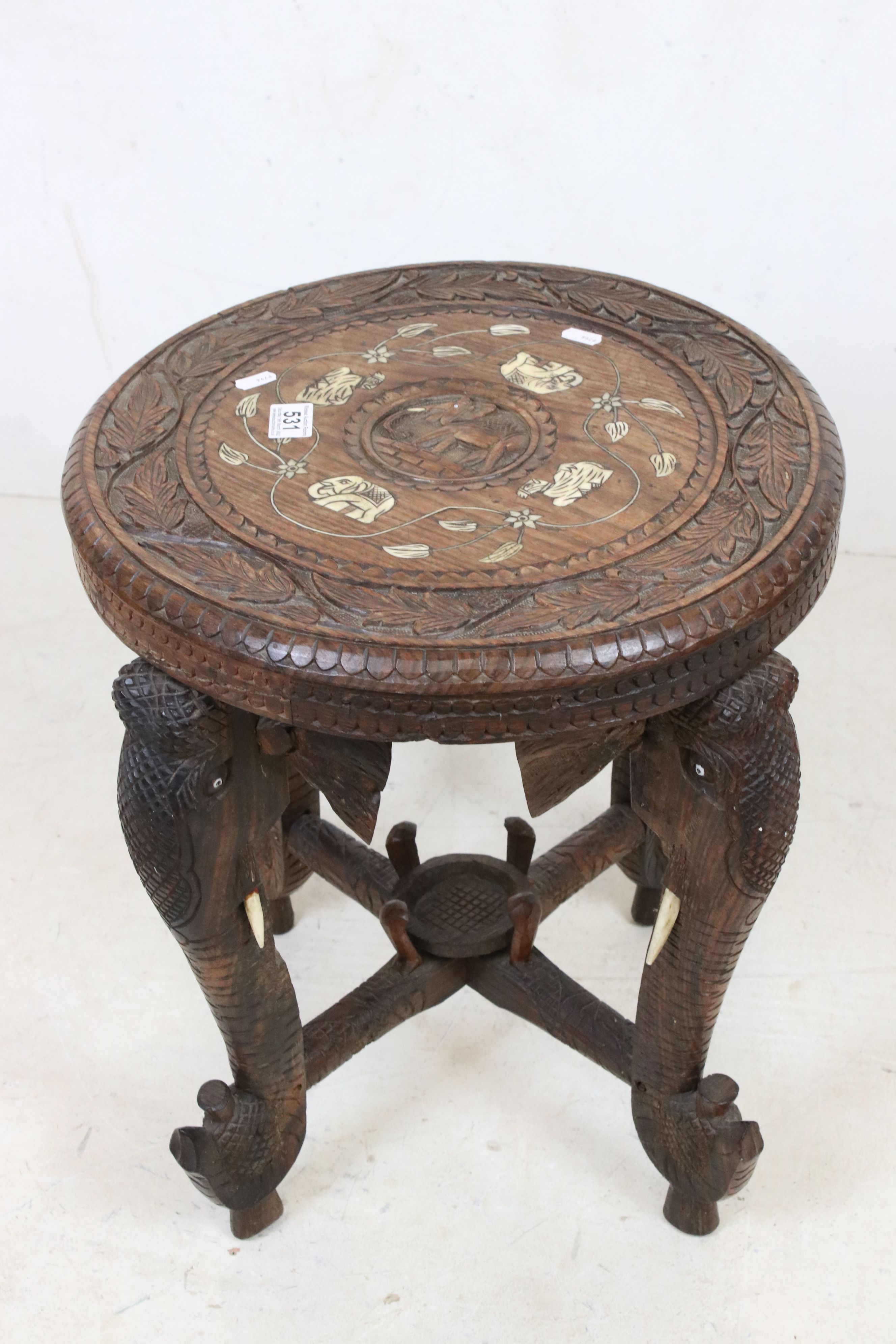 Indian Hardwood Circular Table with bone inlay, the four legs carved in the form of Elephant Heads