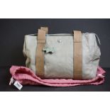 A green Radley handbag with floral metal, floral Radley dog and pink dust bag.