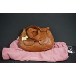 A brown Radley handbag with yellow detailing, yellow Radley dog and pink dust bag.