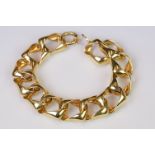 A late 20th century yellow metal curb bracelet.
