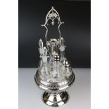 An antique silver plated cruet / condiment centre piece with decorative etched glass bottles.