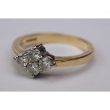 Diamond four stone 18ct yellow gold ring, four small round brilliant cut diamonds in quatre-foil