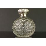 Edwardian silver topped cut glass scent bottle, repoussé floral and foliate scroll decoration to