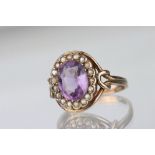 Late Victorian/ Edwardian amethyst and seed pearl 9ct yellow gold ring, the oval mixed cut