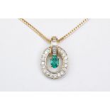 Emerald and diamond 18ct yellow and white gold set pendant necklace, the oval mixed cut emerald