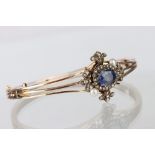 Edwardian sapphire, pearl and diamond 14ct rose gold hinged bangle, the oval mixed cut blue sapphire