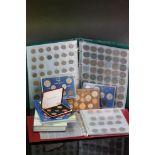 A collection of mainly British pre decimal coins in two albums together with mint coin sets and