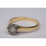 Diamond solitaire 18ct yellow and white gold set ring, the round brilliant cut diamond weighing