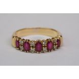 Ruby and diamond unmarked yellow gold half eternity ring, five marquise mixed cut rubies with