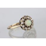 Victorian opal and diamond 9ct yellow gold cluster ring, the round cabochon cut opal displaying