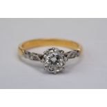 Diamond solitaire unmarked yellow gold and platinum set ring, the round brilliant cut diamond