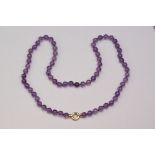 Amethyst bead necklace with 18ct yellow gold bolt ring style clasp, comprising sixty-eight