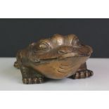 Bronze stylised three legged toad figure holding a coin, signed with character marks