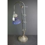 An early 20th century adjustable table lamp with blue glass shade.