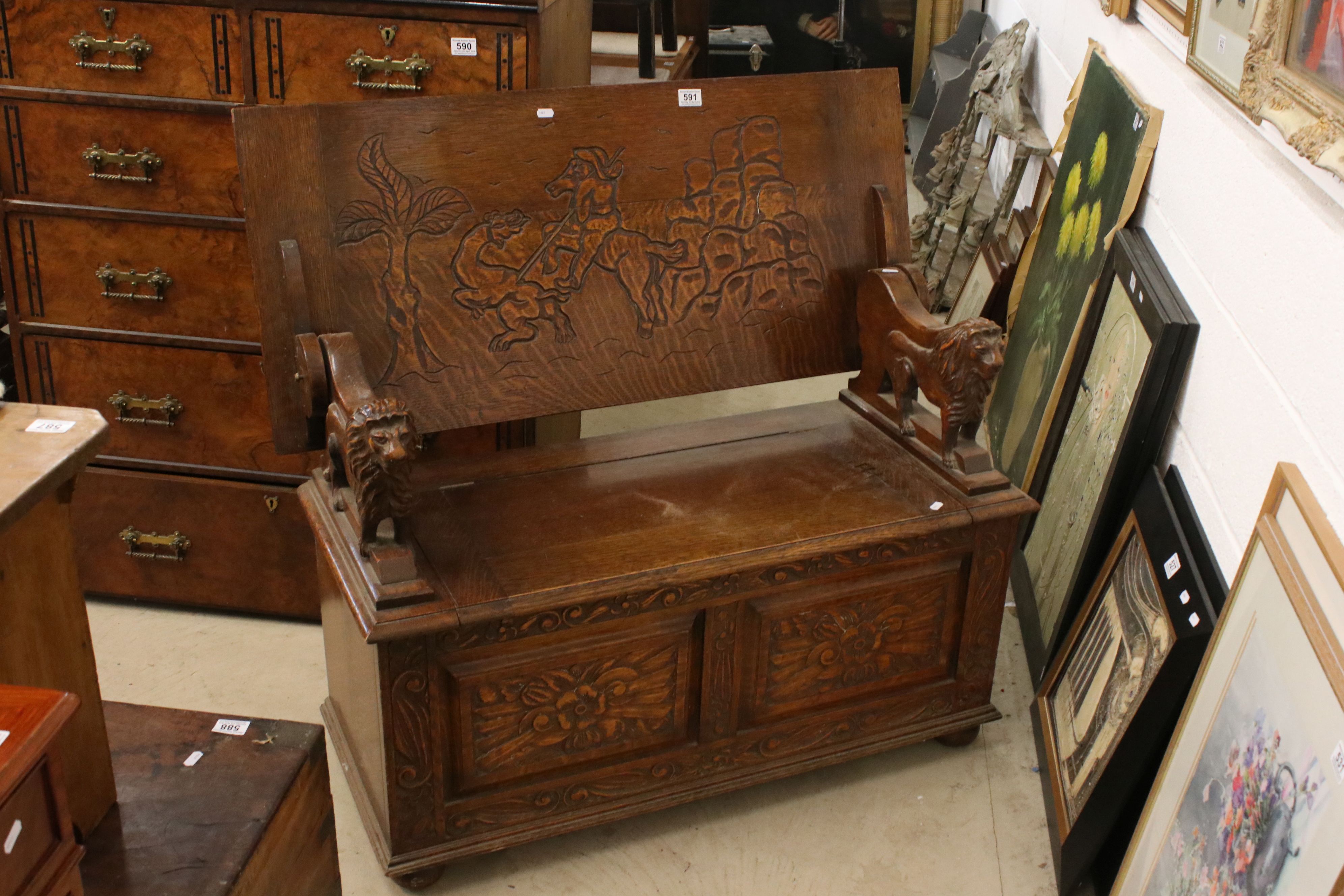 Early 20th century Oak Monk's Bench, the hinged top opening to show a carved scene of George and the