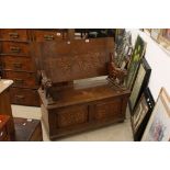 Early 20th century Oak Monk's Bench, the hinged top opening to show a carved scene of George and the