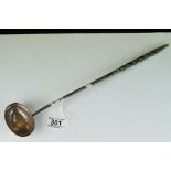 A silver toddy ladle with inset coin dated 1802,