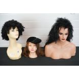 A collection of three contemporary shop display mannequin heads.