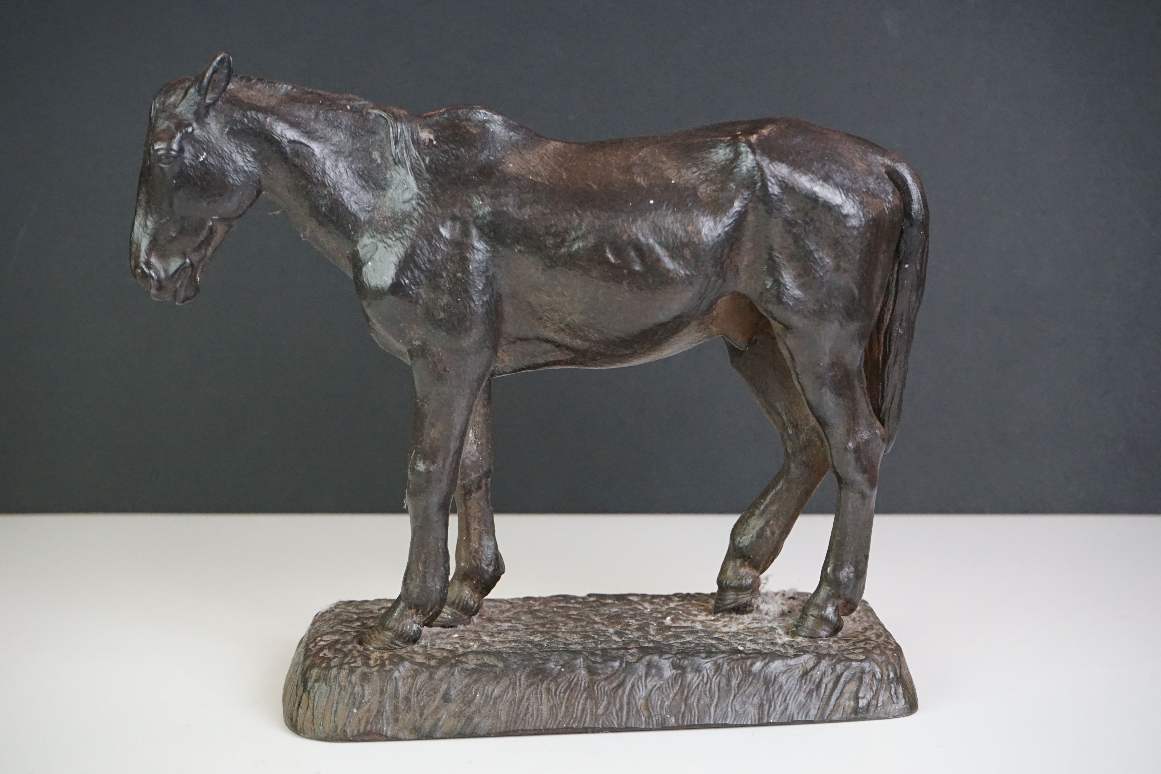 A cast iron door stop in the form of a horse, maker marked to base.