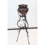 Early 19th century Ornate Wrought Iron Tripod Stand with a later Art Nouveau Copper Jardiniere