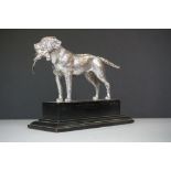 Chrome model of a gundog with pheasant in it's mouth, mounted on a plinth