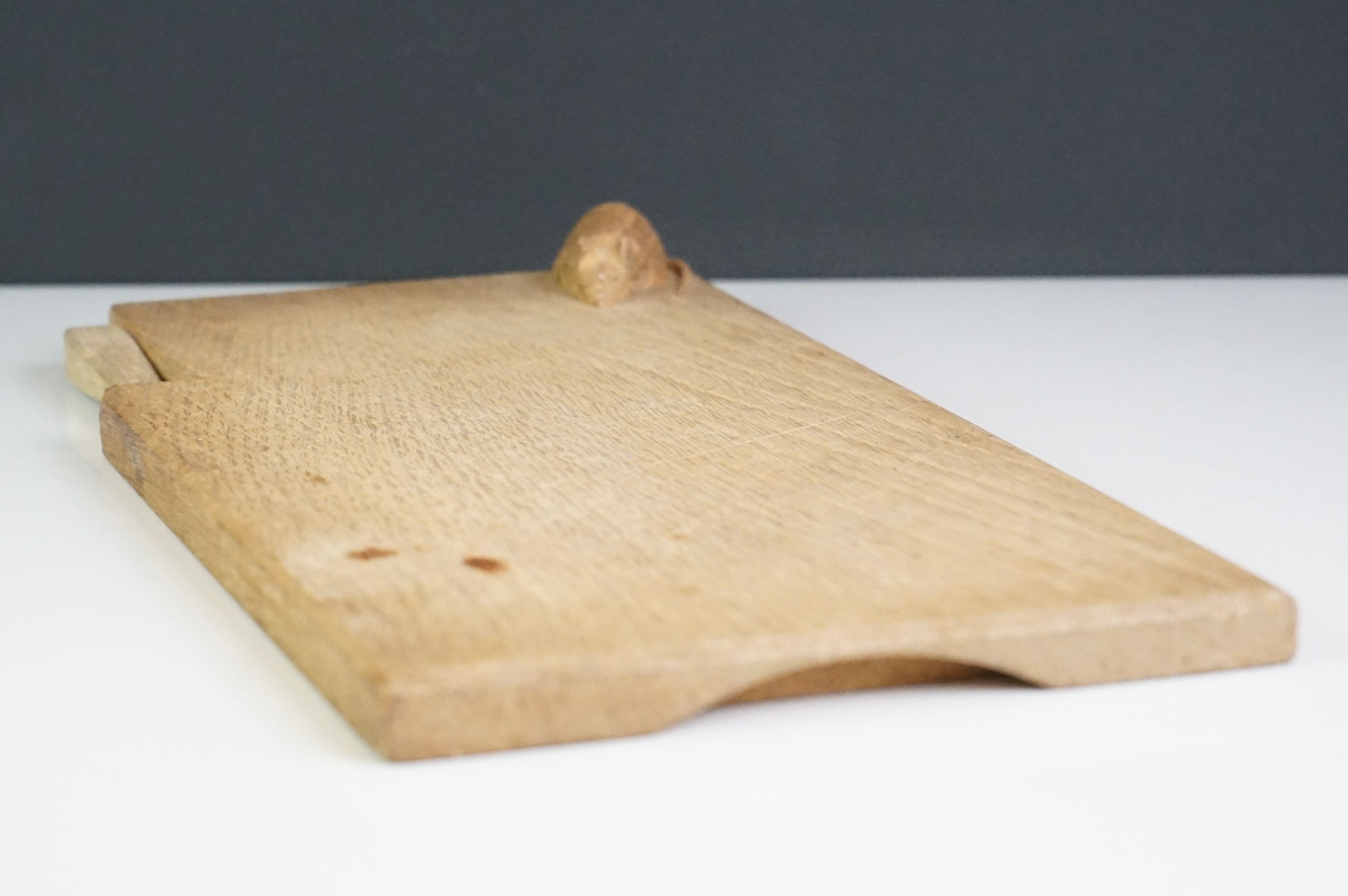 A wooden cheese board and cheese knife in the style of Mouseman Robert Thompson. - Image 2 of 6