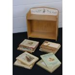 A collection of Beatrix Potter books together with a Peter Rabbit book shelf.