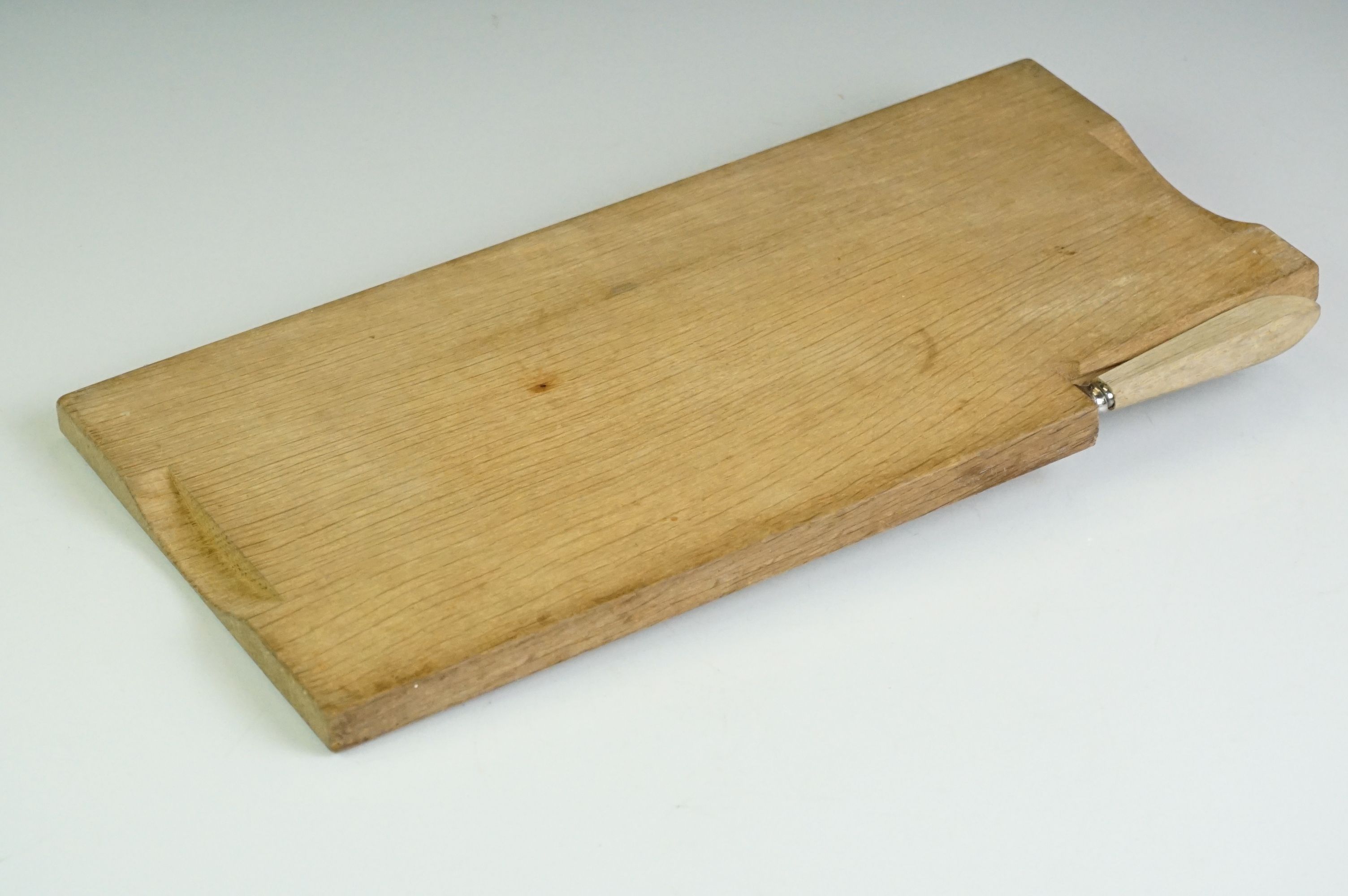 A wooden cheese board and cheese knife in the style of Mouseman Robert Thompson. - Image 6 of 6