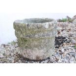 A reconstituted stone garden plant pot.