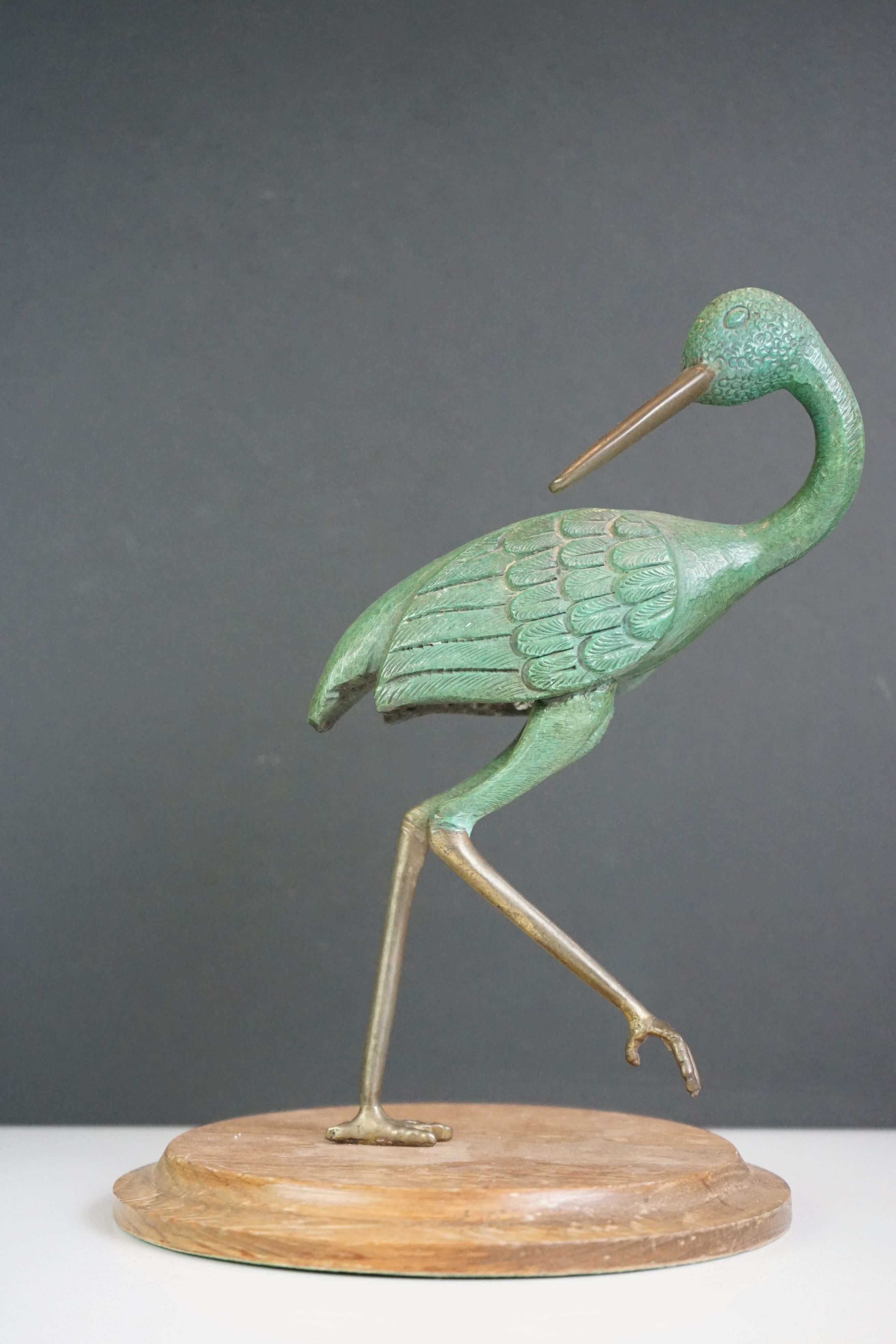 Painted sculpture of a bronze wader type bird, mounted on a wooden plinth