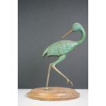 Painted sculpture of a bronze wader type bird, mounted on a wooden plinth