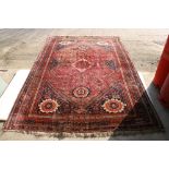 Qashqai Rug, red ground with medallion pattern, approx 213cm x 310cm