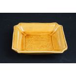 Small Chinese Square Dish, the ochre glazed with impressed design to bowl of a dragon, 10cm diameter