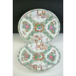 Pair of Chinese Cantonese Famille Rose Plates decorated with figures and flowers, 26cm diameter